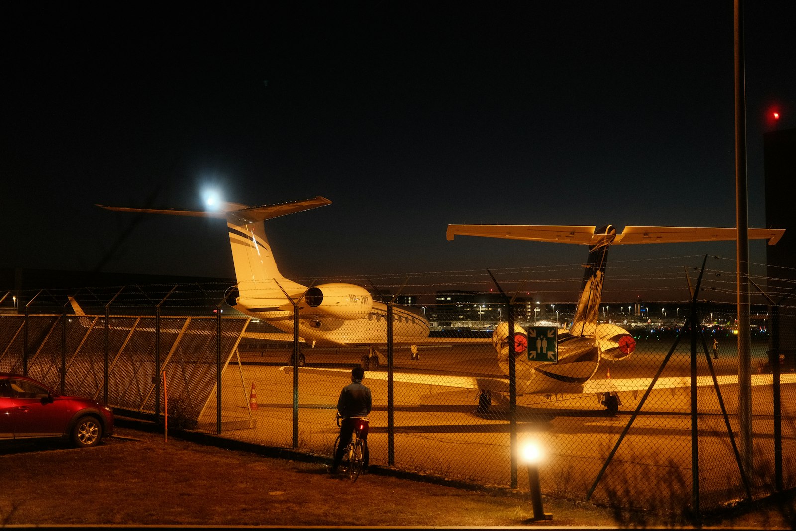 Executive boarding a private jet via airstairs at night