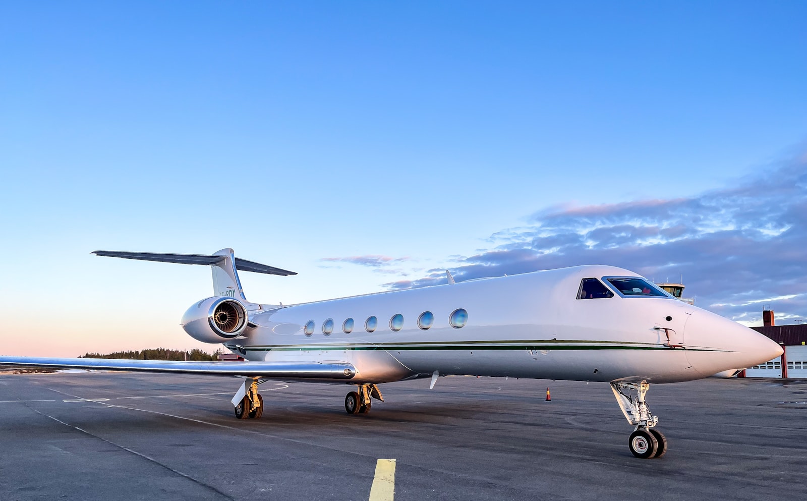 Light business jet exterior against an evening sky